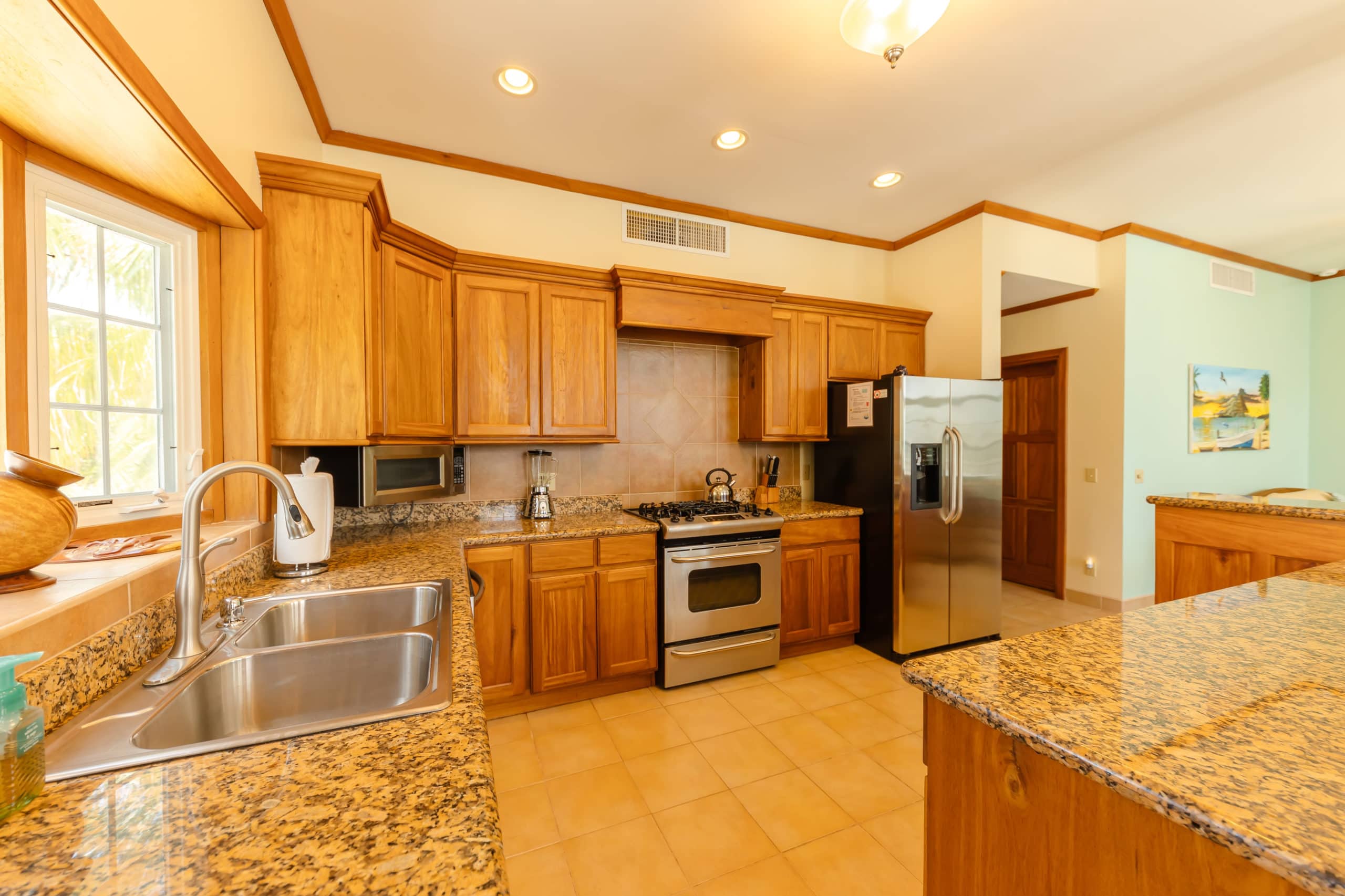 Modern kitchen with stainless steel appliances, granite countertops, and all the necessary cooking essentials, providing a convenient and functional space for meal preparation.