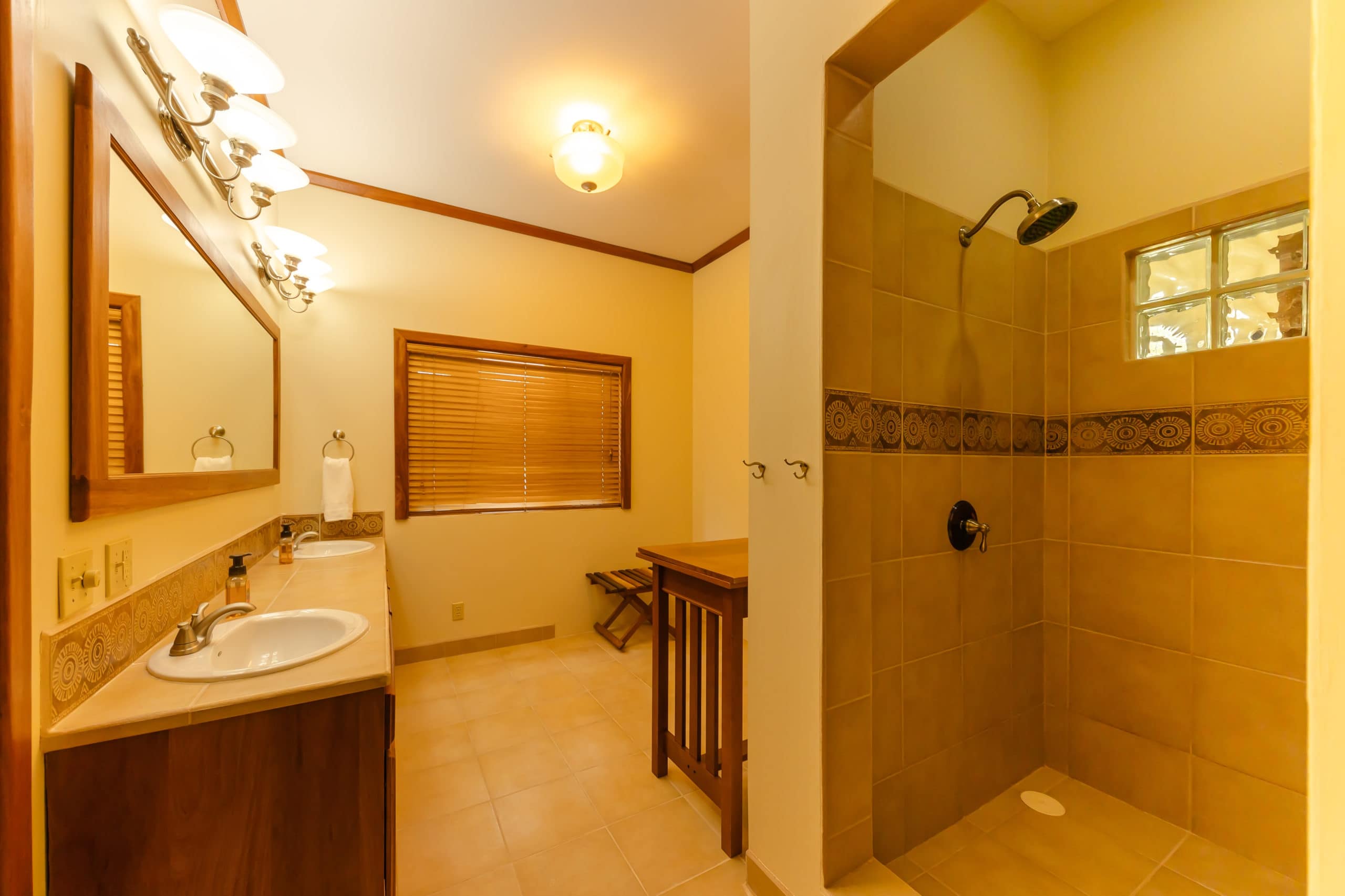 Luxurious en-suite bathroom with a modern design, including a spacious walk-in shower, elegant vanity, and contemporary fixtures